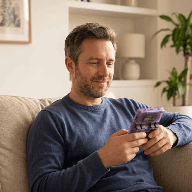 Person playing the CurveveraMax Pro 2.0 R36S retro gaming console at home
